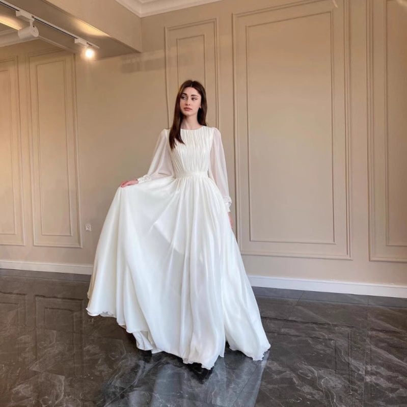 Women's White Chiffon Pleated Maxi Dress with Sheer Blouson Sleeves - Maisie London