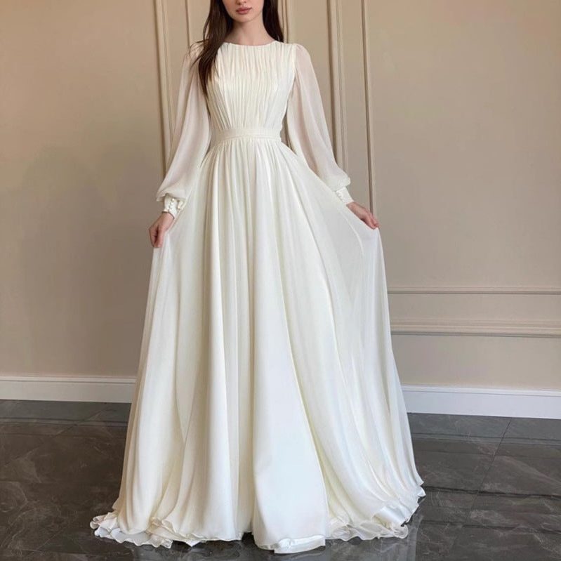 Women's White Chiffon Pleated Maxi Dress with Sheer Blouson Sleeves - Maisie London